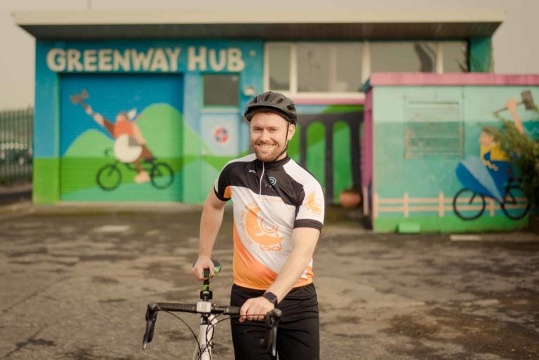 Cyclist outside Greenway Hub at Viking Hotel Waterford