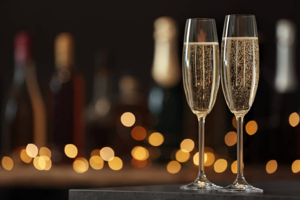 Prosecco in glasses with lights in background