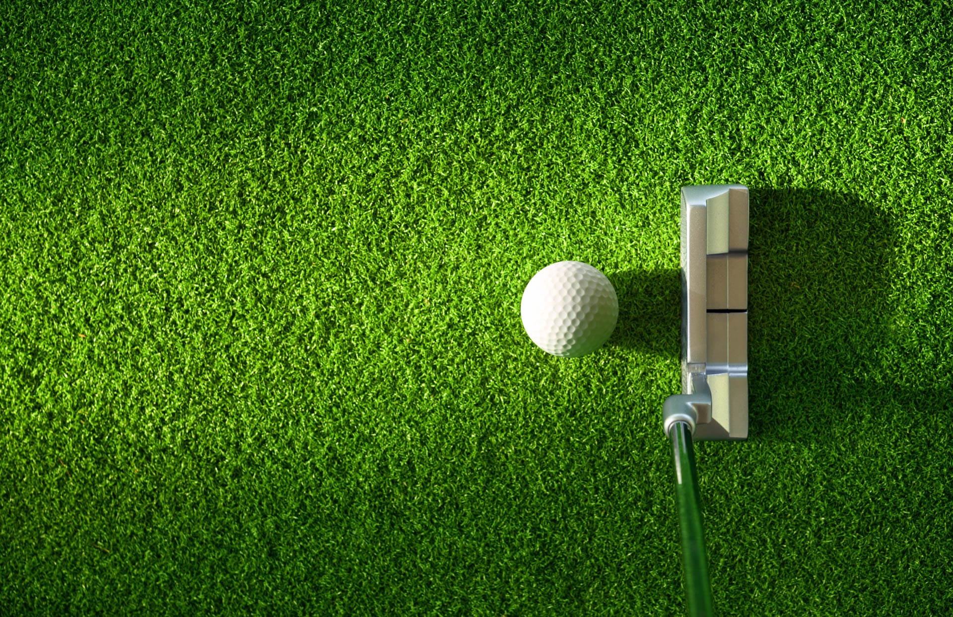 Close up view of golf club beside golf ball
