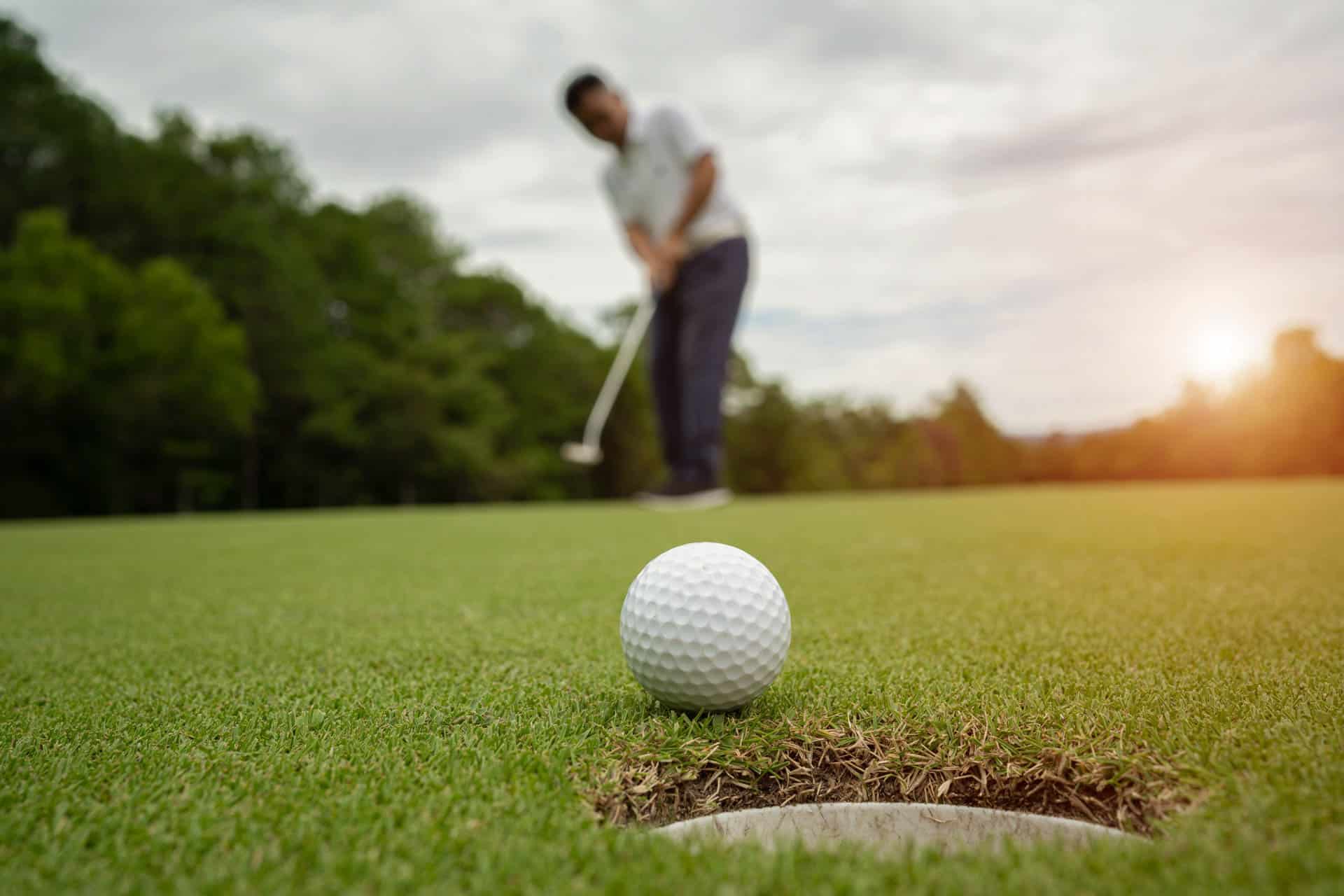 Person teeing off golf ball