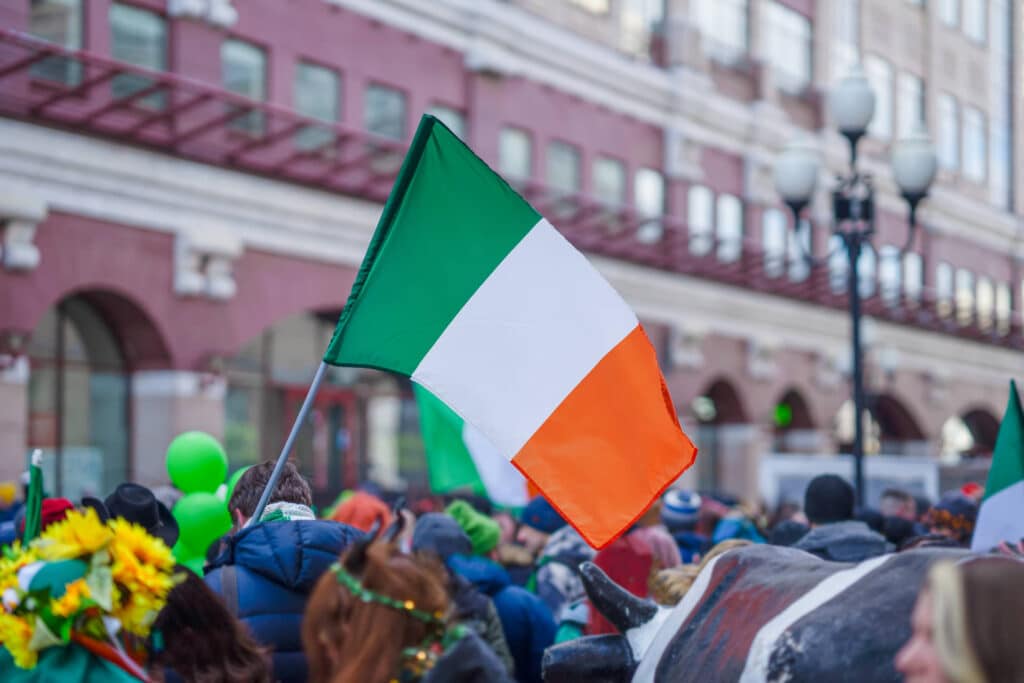 St.Patricks Day Parade - Irish flag flown above the crowd