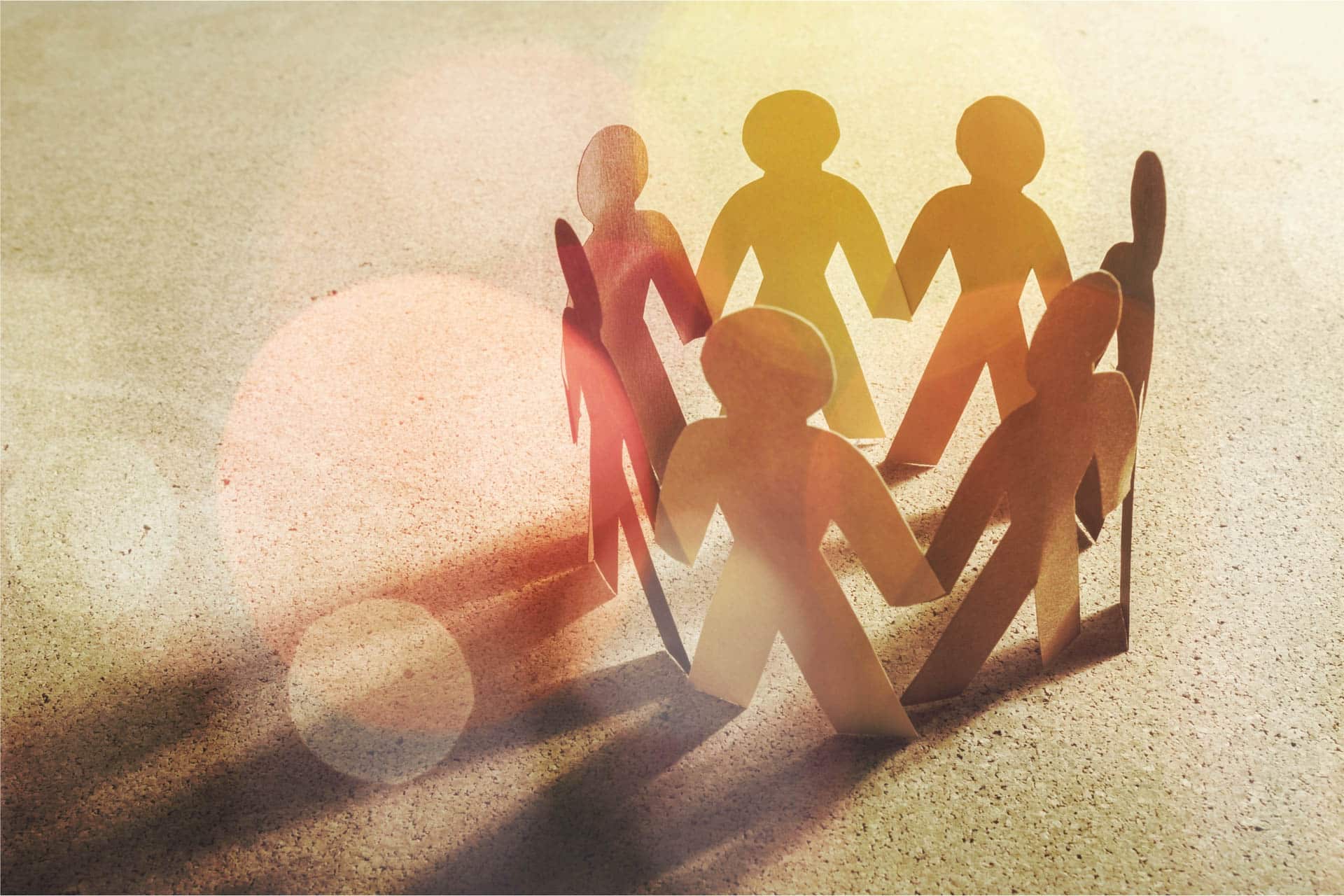 Wooden stickmen holding hands to signify partnerships