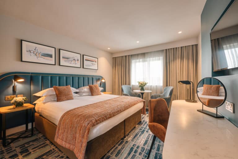 Superior king room with a large window and warm lighting