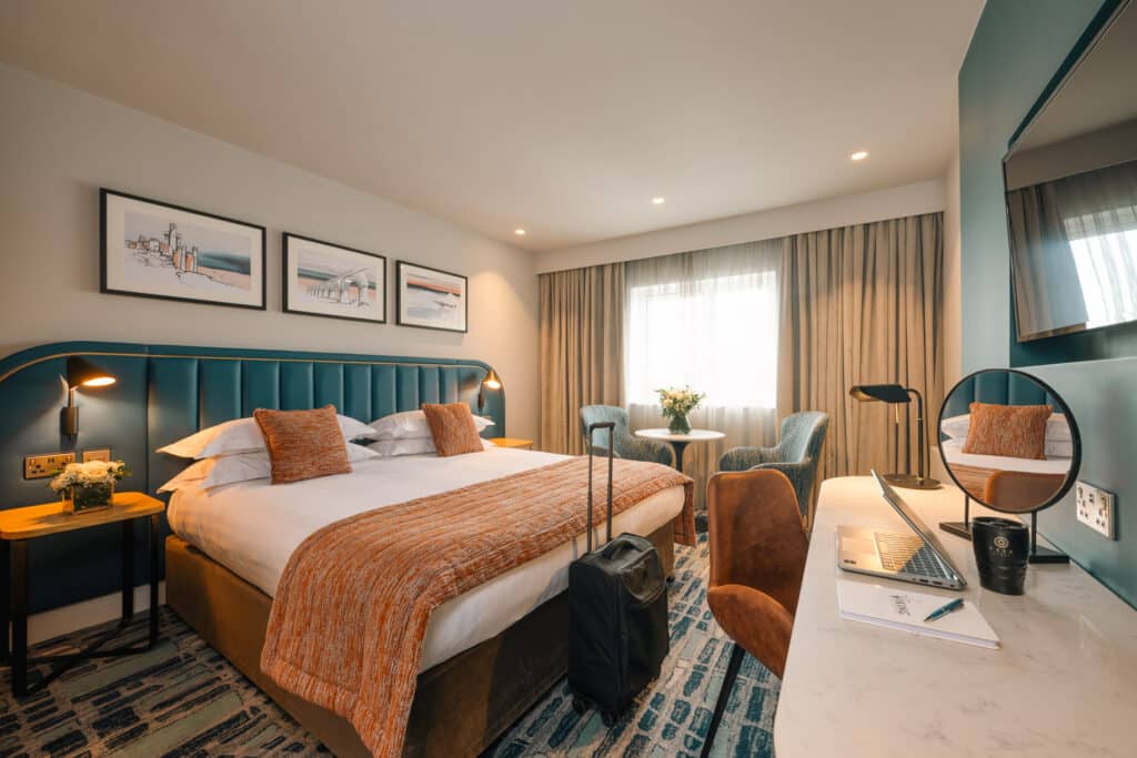 Superior king room with a view of the window and bed throw