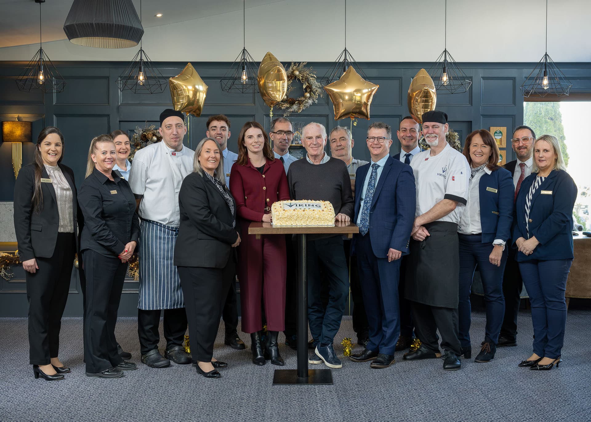The full team of the Viking Hotel Waterford to celebrate their four stars in front of a cake